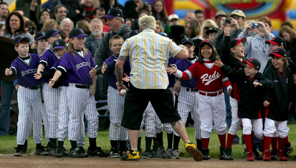 After local restauranteur and television personality Guy Fieri showed up at the Mark West Youth Little League opening day to throw out the first pitch, Fieri high fived players from the Farms division.  According Mark West officials his appearance was "Top Secret", Saturday April 2, 2011 in Larkfield. (Kent Porter / Press Democrat) 2011