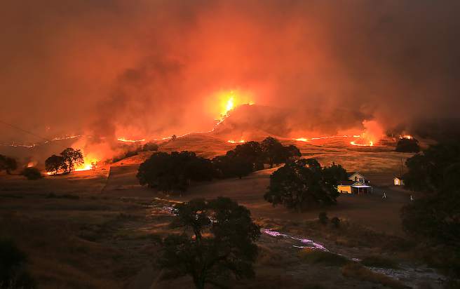 Fire roars in to a valley off Morgan Valley Road, during the Rocky Fire near Lower Lake Wednesday July 29, 2015. (Kent Porter / Press Democrat) 2015