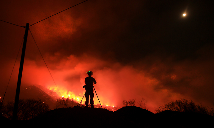 Southern California based fire photographer Stuart Palley photographs the Rocky Fire as it burns up and over a ridge along Morgan Valley Road early Thursday morning  July 30, 2015.  The fire has grown to 8,000 acres since yesterday afternoon. (Kent Porter / Press Democrat) 2015