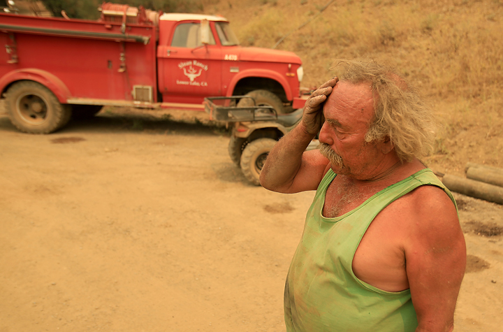 Larry Sloan protected his house with his own fire truck, background, at the height of the Rocky Fire Wednesday night near Lower Lake, Thursday July 30, 2015. (Kent Porter / Press Democrat) 2015
