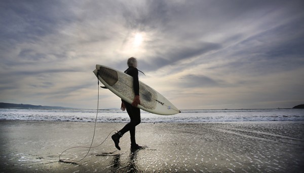 63 year-old Eddie Scanlon of Petaluma heads out to the Doran Park surf, Tuesday Jan. 12, 2016 in Bodega Bay. (Kent Porter / Press Democrat) 2016
