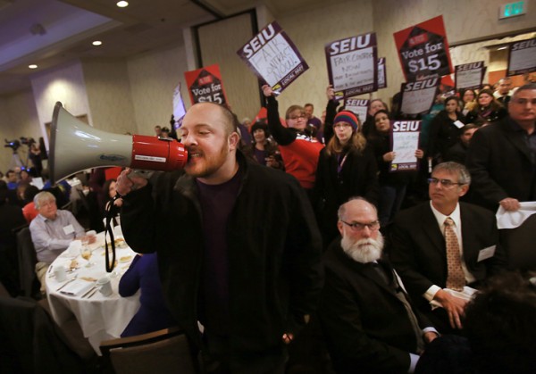 Protesters from the SEIU 1021 rush their way past security guards during the State of the County report at the Double Tree Hotel in Rohnert Park Wednesday, January 27, 2016. (Kent Porter / Press Democrat) 2016