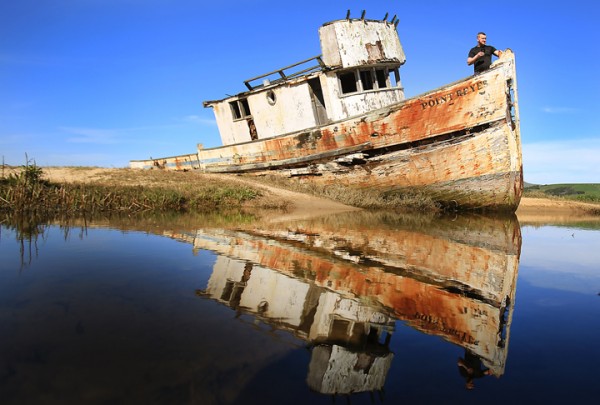 Stanislaw Swiech of Chicago takes in the Tomales Bay aboard the Pt. Reyes shipwreck, an iconic destination of photographers and tourists alike in Inverness, Thursday Feb. 25, 2016. Several nights ago, the boat caught fire, hours after a photoshoot burning the entire stern of the vessel. (Kent Porter / Press Democrat) 2016