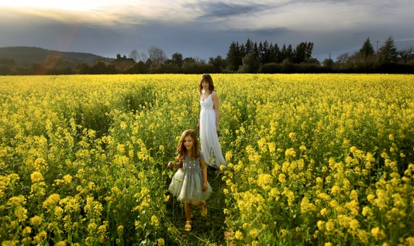 Lillie Smallcomb, 5. and her mother Jennie of Santa Rosa take advantage of the warm weather to relax in a mustard field near Kenwood, Monday Feb. 29, 2016 as they prepare to model dresses for a commercial photographer.  (Kent Porter / Press Democrat) 2016