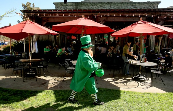Greendog Rescue volunteer  Gary Archuleta  carries his pot of gold during the Annual Drinks for the Dogs event, Thursday March 17, 2016 at the Healdsburg Bar and Grill. (Kent Porter / Press Democrat) 2016