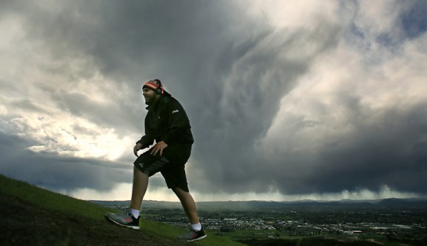 Storm clouds add a dramatic flair as Trevor Shatara takes a hike at Taylor Mountain Regional Park and Open Space Preserve Monday March 28, 2016. (Kent Porter / Press Democrat) 2016