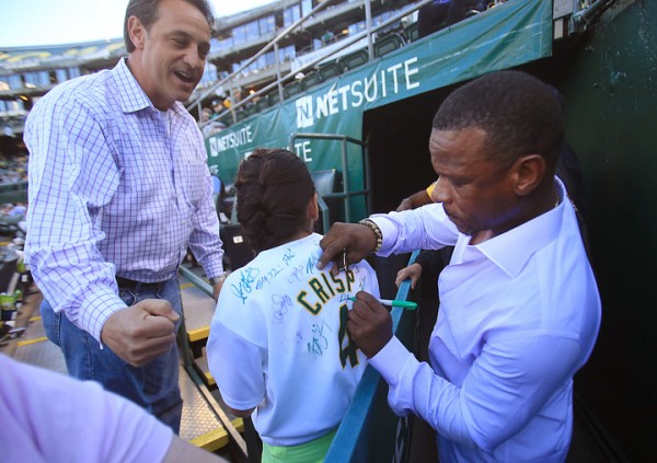 Emma Hatcher, 12, gets an autograph from Rickey Henderson as her dad Jeff Hatcher celebrates prior to the A's opener against the White Sox,  Monday April 4, 2016.  The two are from Livermore. (Kent Porter / Press Democrat ) 2016
