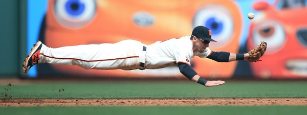 Giants third baseman Matt Duffy dives for a hot liner off the bat of Dodger  Yasiel Puig in the third inning-he later scored- during opening day at AT&T Park in San Francisco, Thursday April April 7, 2016. (Kent Porter / Press Democrat ) 2016