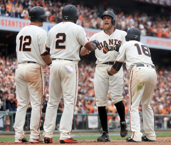 Hunter Pence greets, from left, Joe Panik, Denard Span, Angel Pagan at home after smacking a grand slam in the eighth inning, during the  Giants opening day against the Dodgers at AT&T Park in San Francisco, Thursday April April 7, 2016. (Kent Porter / Press Democrat ) 2016