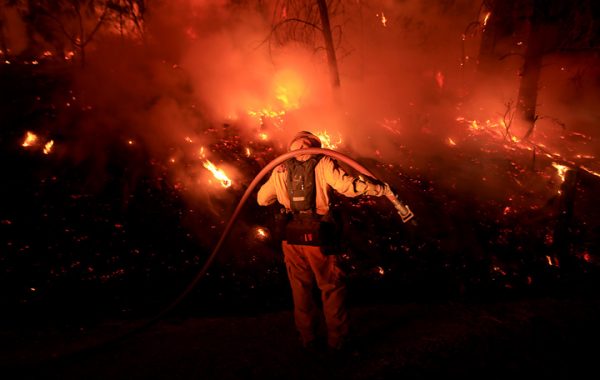 Bennett Leda of Healdsburg's Cal Fire station monitors the Clayton fire as it approaches Morgan Valley Road near Lower Lake, Sunday August 14, 2016 in Lake County. (Kent Porter / Press Democrat) 2016