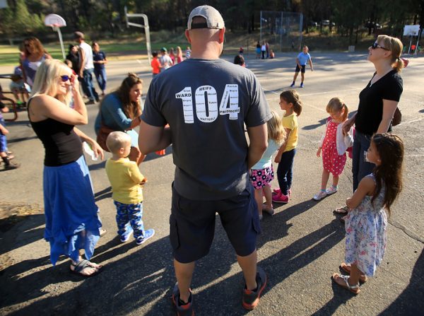 Cal Fire dozer operator Drew Bohan joined his wife Nahani, left, for their daughters first day of kindergarten at Cobb Elementary School, Wednesday Aug. 10, 2016. Lohan wears a shirt dedicated to the 104 Boggs helitac crew that was burned over in the early stages of the Valley fire. (Kent Porter / The Press Democrat) 2016