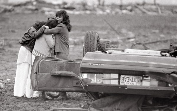 The morning after the tornado, families began to find their loved ones as the walked the path of the tornado. 121 people were injured. (©Kent Porter) 