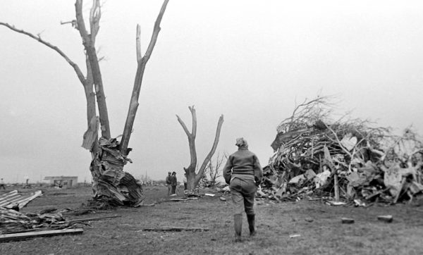 Peggy Walker looks at the damage May 23, 1987, the morning after Saragosa, Texas was hit by an EF4 tornado, killing 30 people. (© Kent Porter) 