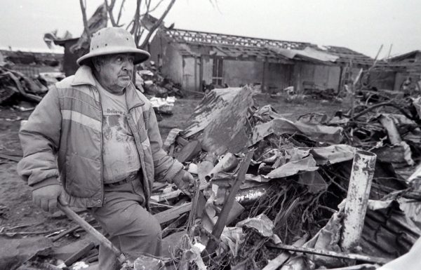 A resident of Saragosa looks over the damage caused by the tornado the May 23, 1987. (© Kent Porter)